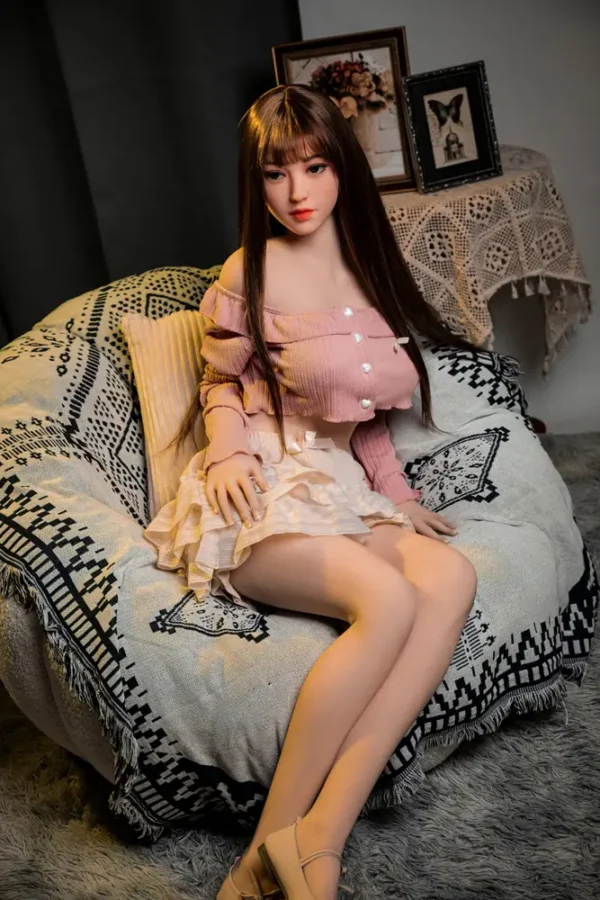 A Asian style big booty d-cup ultar realistic sex doll sits on the sofa.