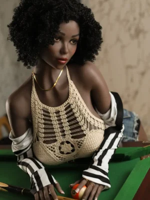 A black afro sex doll wearing an apricot halter is leaning over a pool table.