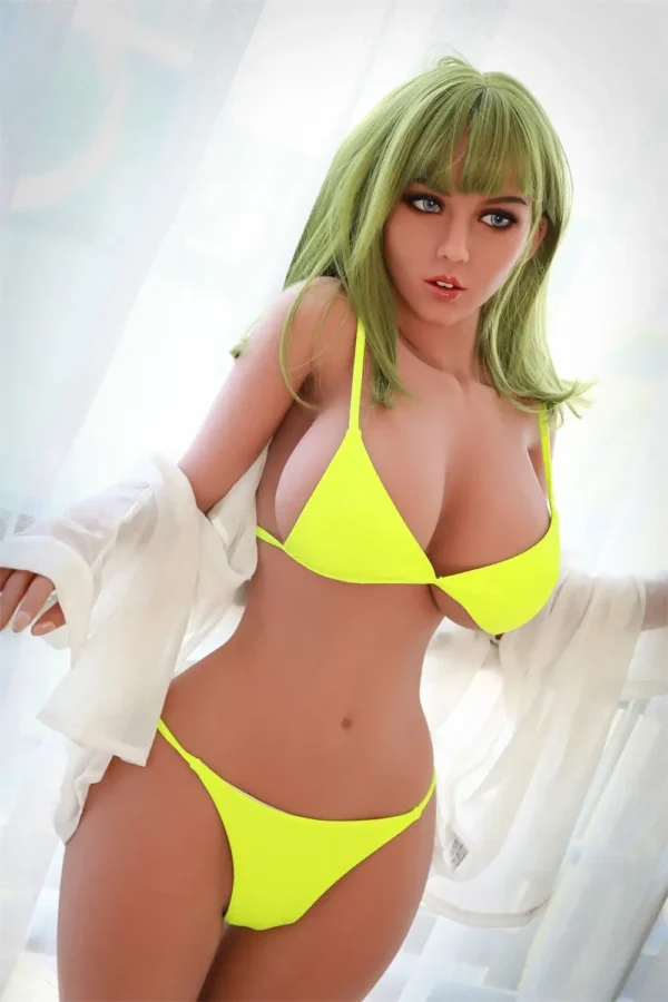 A life size leggy bikini tpe young sex doll leans against a railing,wearing a green bikini.