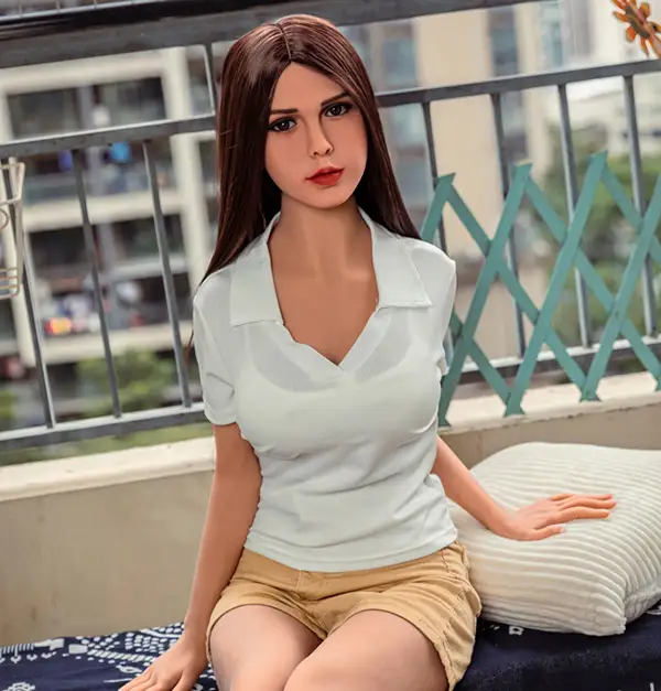 A sex doll, wearing a shirt collar top and yellow shorts, sits on the balcony.