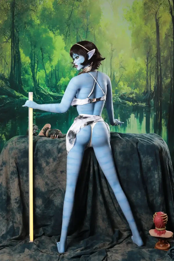 An alien avatar big boobs sex doll stands on the ground, and holds a stick in her left hand.