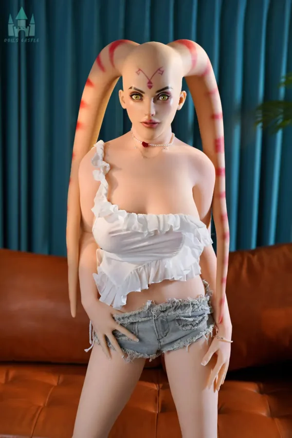 A silicone head alien sex doll with lekku stands on the ground.